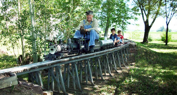 Jeff coming around the bend over his tressle located near the southeastern corner of our railroad.